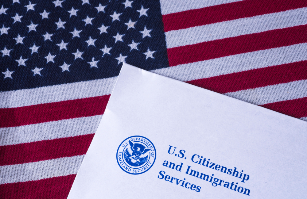 Letter from US Citizenship and Immigration Services on Flag of United States of America.