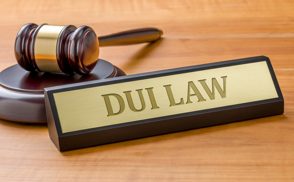 A gavel and a name plate with the engraving DUI Law